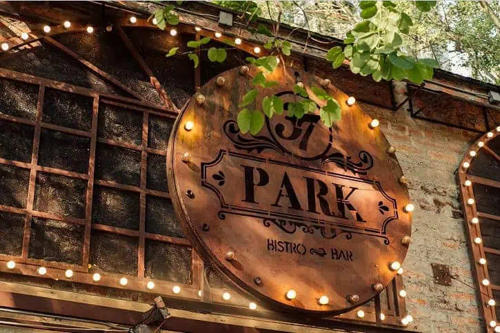 The public enjoying events in a welcoming, outdoor space decorated with lights and plants, ideal for weddings, corporate events, and exclusive celebrations.