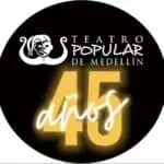 Logo disc of the Teatro Popular de Medellín in celebration of its 45th anniversary, with an icon of a female figure and highlighted text in yellow and white.