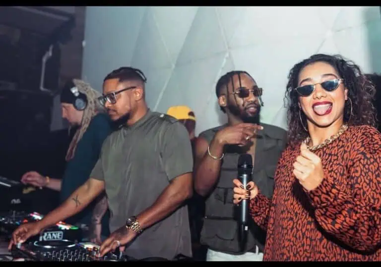 Live music party with a DJ, young people enjoying the vibrant atmosphere at a social event in Colombia.