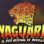 Vaca gigante con letras de neón y logo de El Aguardar, festival de Medellín, cartel de evento con temática de música y cultura urbana, imagen colorida y llamativa.