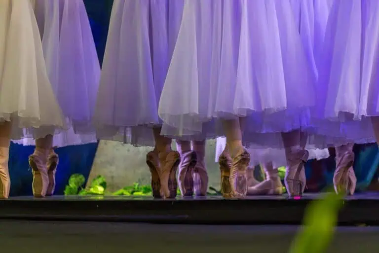 Bailarinas ballet en escenario durante presentación en vivo.