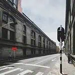 Urban street footage in the city. Historic buildings, pedestrian signs, and traffic lights, in a modern, architectural city setting, ideal for event content and urban tourism.