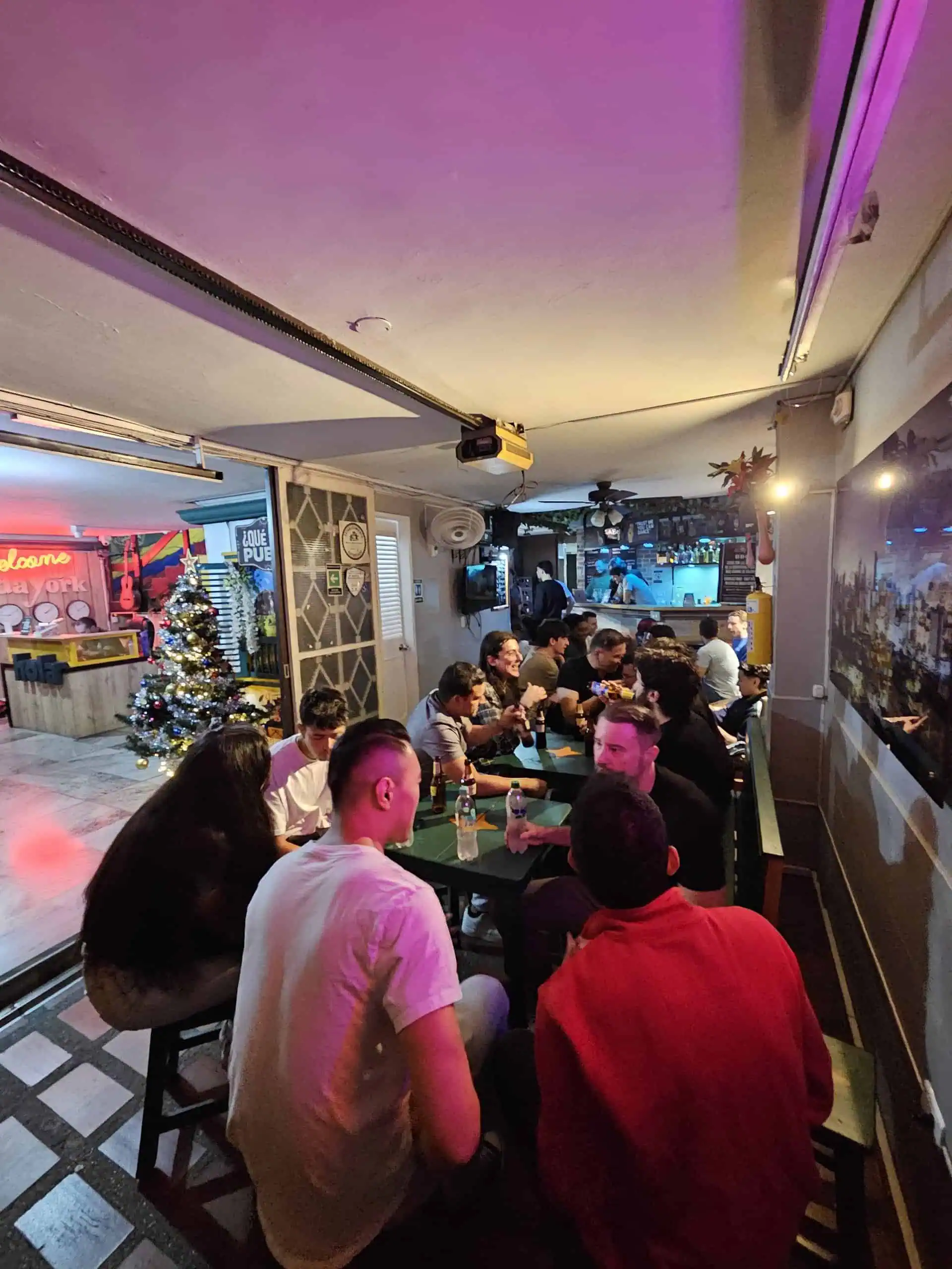 An event atmosphere in a restaurant with a group of people enjoying themselves, Christmas decorations, and a festive atmosphere, highlighting the organization and service provided at social and corporate events in Colombia.