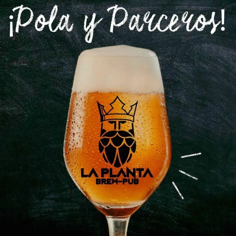 一杯印有 La Planta Brew Pub 标志的精酿啤酒，黑色石板背景，旨在宣传波哥大的啤酒活动和体验。