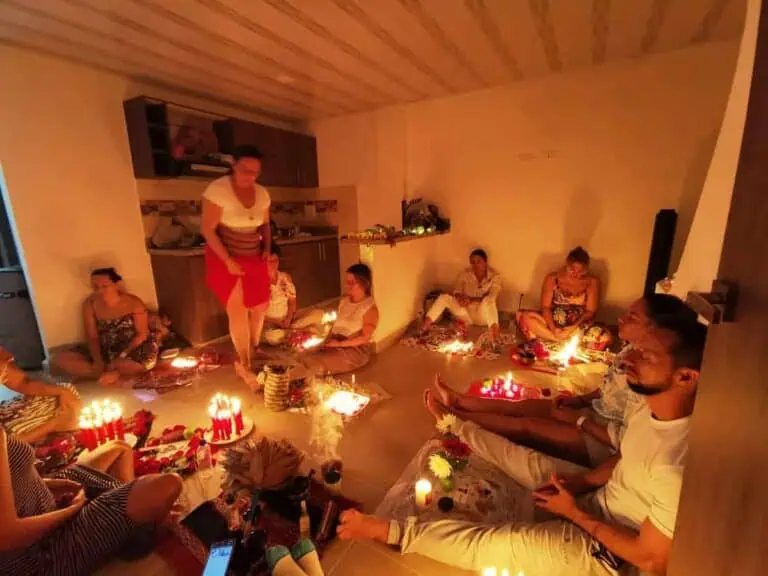 Traditional celebration with candles and offerings in a warm and welcoming atmosphere during an indoor family ceremony in Colombia.