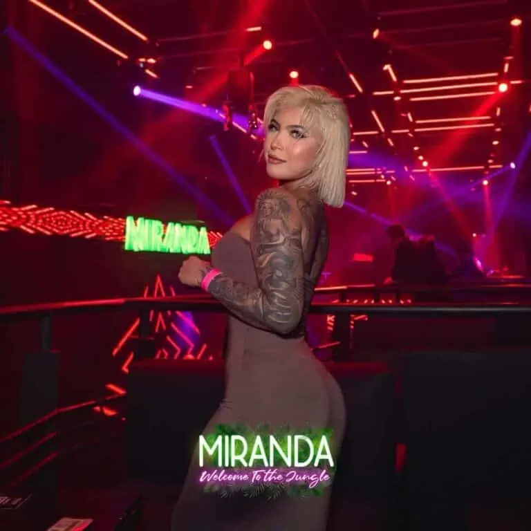 Neon lights at a DJ event with attendees in a club setting featuring a live show, promoting the event and entertainment experience in Medellín.