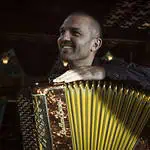 一位充满灵魂的手风琴演奏家在哥伦比亚热闹的活动场所进行表演，捕捉了哥伦比亚音乐和文化的活力精髓，为活动策划和娱乐服务提供素材。