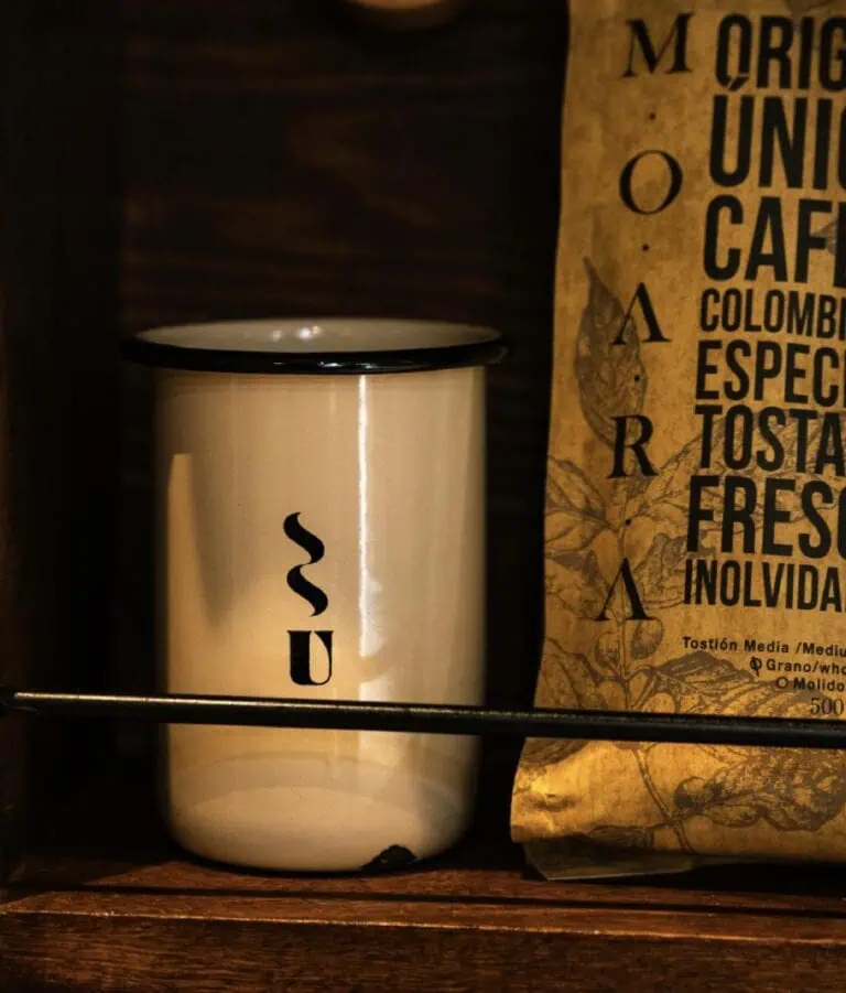 White ceramic mug with black design, ideal for hot drinks in cafes and events.