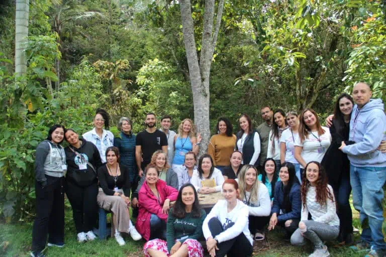 Various attendees at a nature event in a forest, participating in a team-building activity or outdoor workshop, promoting networking and collaboration in an ecological setting.