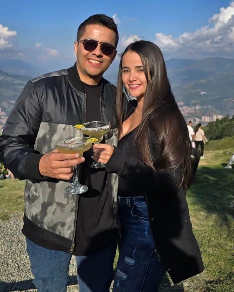 在户外活动中与朋友们一起享用鸡尾酒，在大自然中庆祝，欣赏山脉和城市的全景，气氛欢快喜庆。