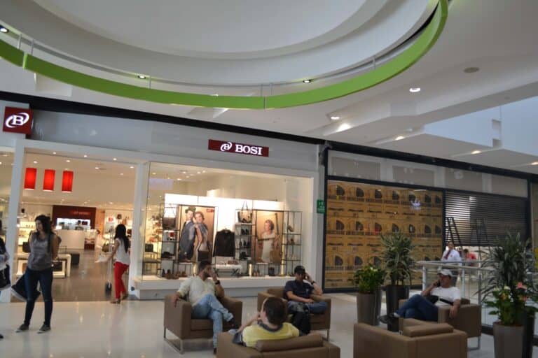 Belleza y moda en centro comercial colombiano con tiendas de marca y espacio de descanso.