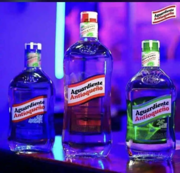 Antioqueño Aguardiente is bottled with visible labels in a bright neon-lit environment, reflecting a festive and celebratory style, ideal for events and alcoholic beverage promotions in Colombia.