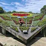 Un jardin avec un design floral, une structure moderne et une végétation variée, idéal pour les événements et les activités de plein air en Colombie.