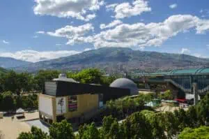 Modernes Veranstaltungszentrum in Medellín mit Blick auf die Stadt und die Berge, mit moderner Architektur und umgeben von grünen Außenflächen in einer natürlichen und urbanen Umgebung.