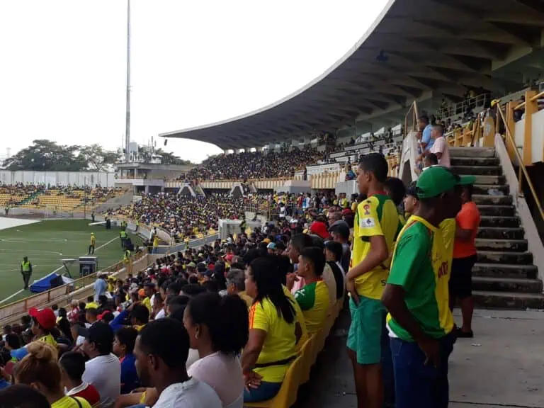 Stadium seats during a sporting event in Colombia. Large crowd, lively atmosphere, spectators of different ages cheering on their team. Live footage of sporting events in Colombia.