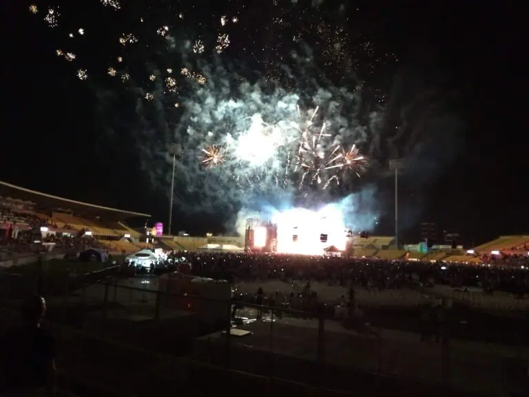 Fireworks display at a stadium during a nighttime event in Colombia. Celebration with lights and pyrotechnics at an outdoor concert or sporting event.