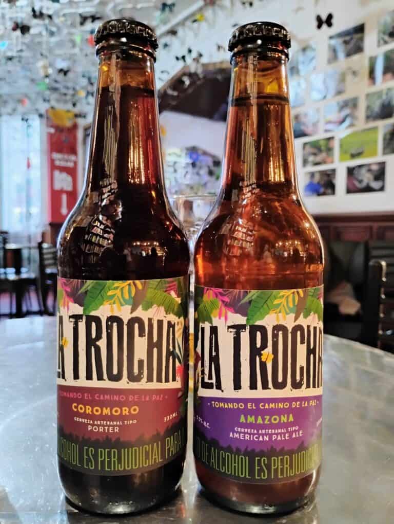Cerveza artesanal La Trocha en La Casa de la Paz, en un ambiente acogedor y decorado con fotos y detalles que reflejan la cultura local, ideal para disfrutar en eventos y reuniones sociales.