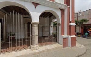 Puerta de entrada al antiguo convento y cárcel en el distrito, con arcos y estructura colonial.