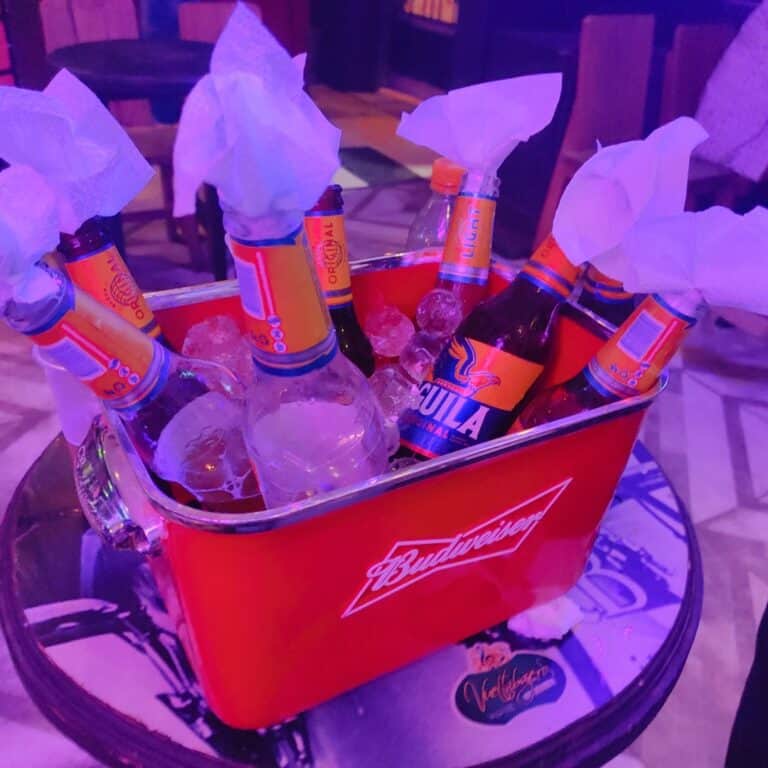 Cerveza en hielo con botellas de cerveza en un evento en Cartagena, resaltando la marca Budweiser y la cultura local.